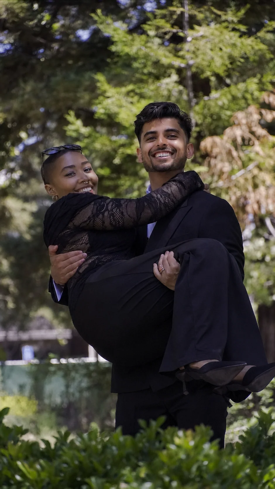 Akshat carrying Jade as they celebrate after the wedding