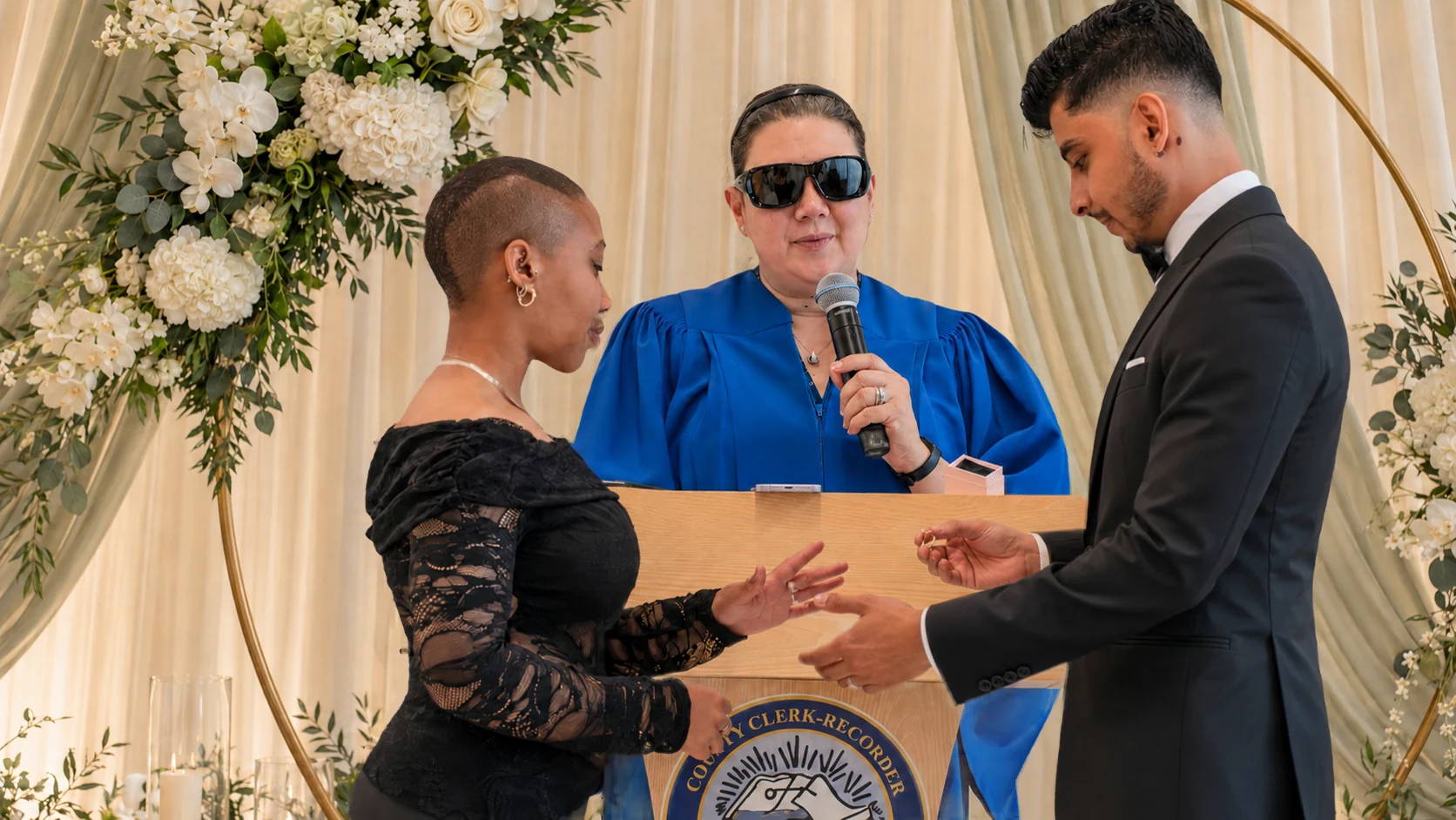 Akshat placing Jade's wedding ring on her hand