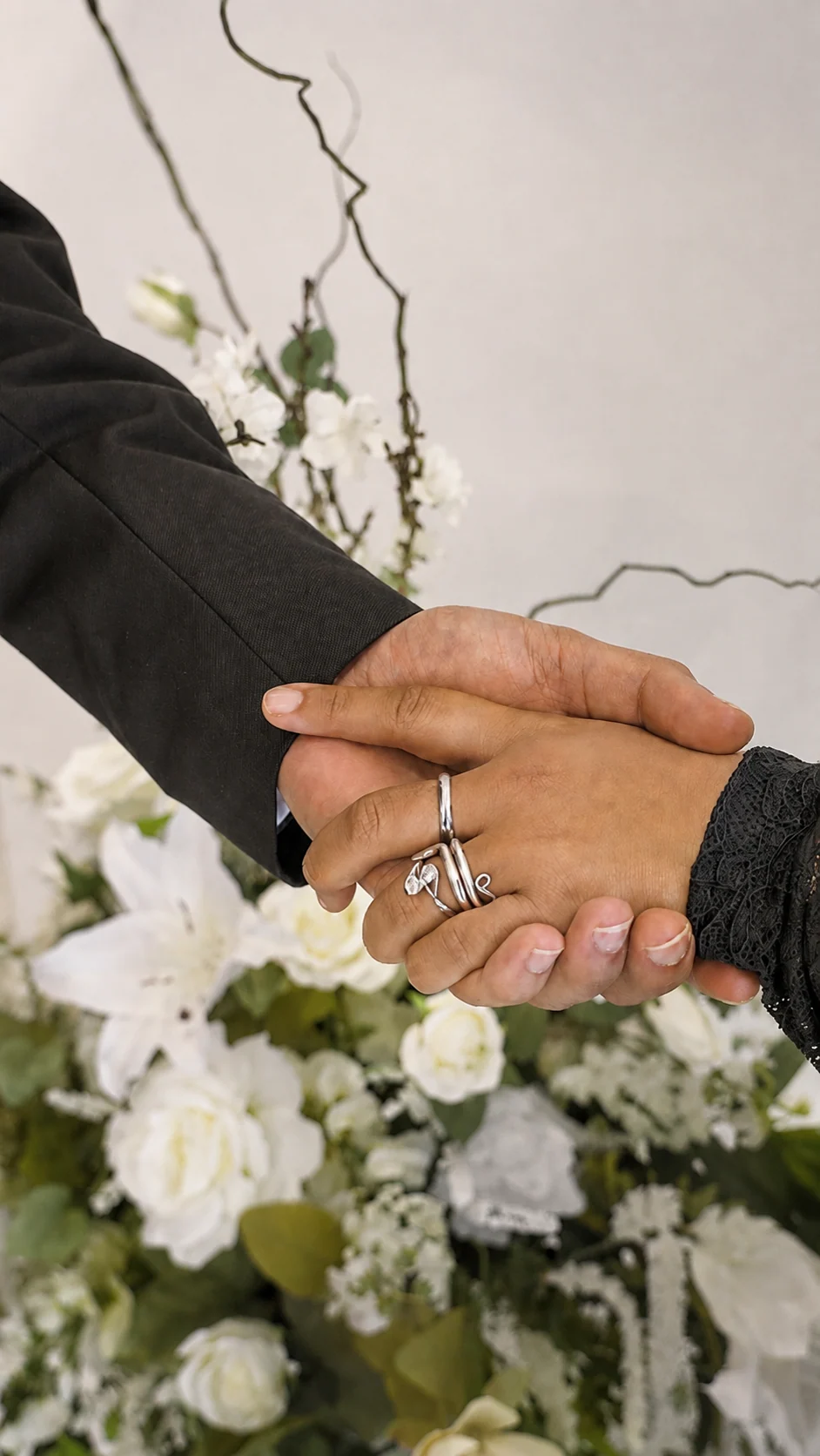 Akshat and Jade holding hands and showing their wedding rings